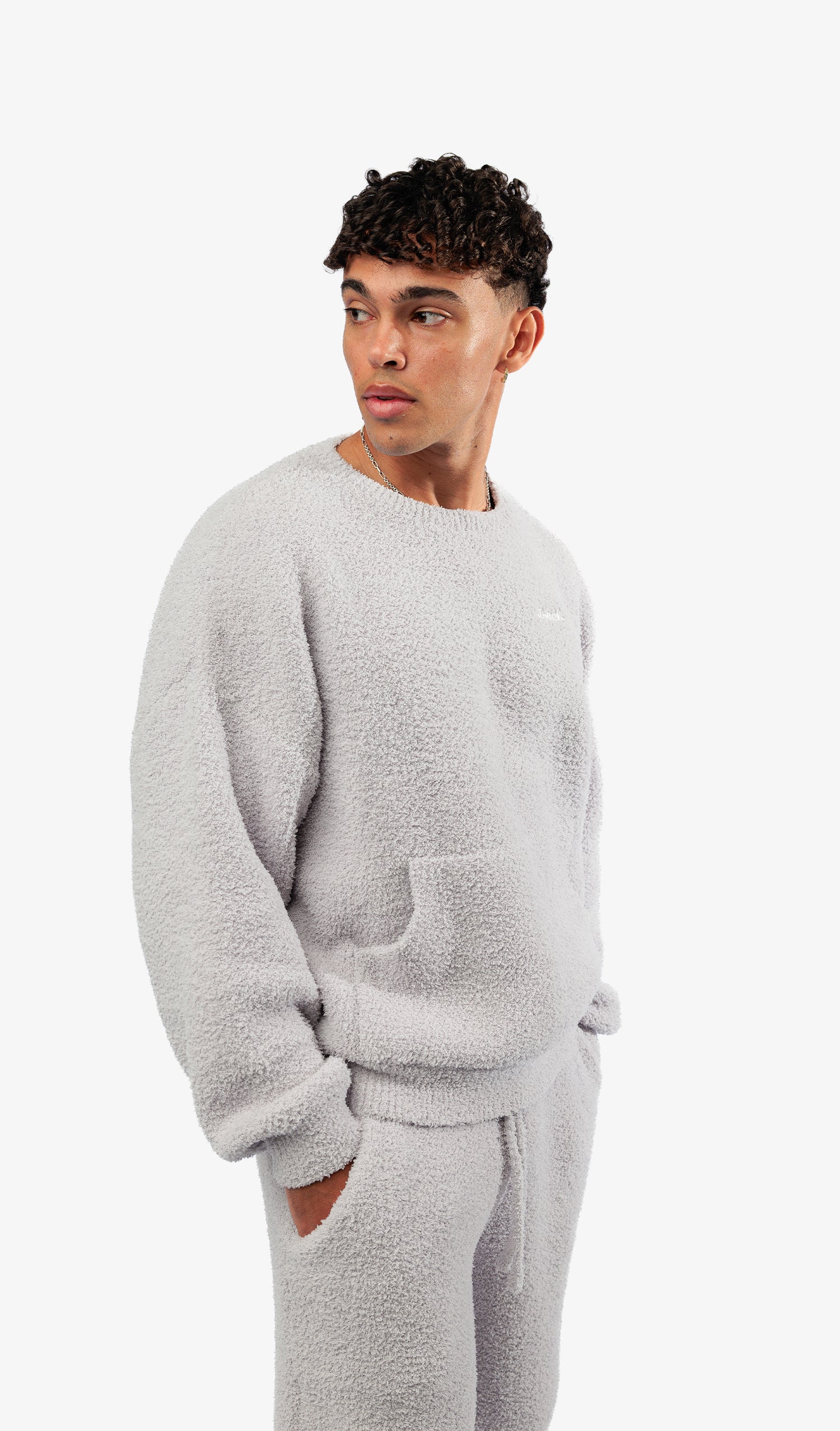 Woman wearing a gray fleece outfit on a white background